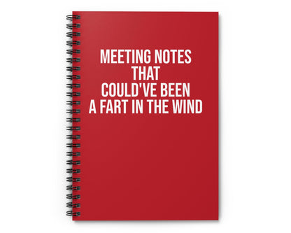 Red notebook with humorous text on a white background