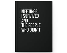 Black notebook with white text on a white background