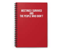 Red notebook with white text on a white background