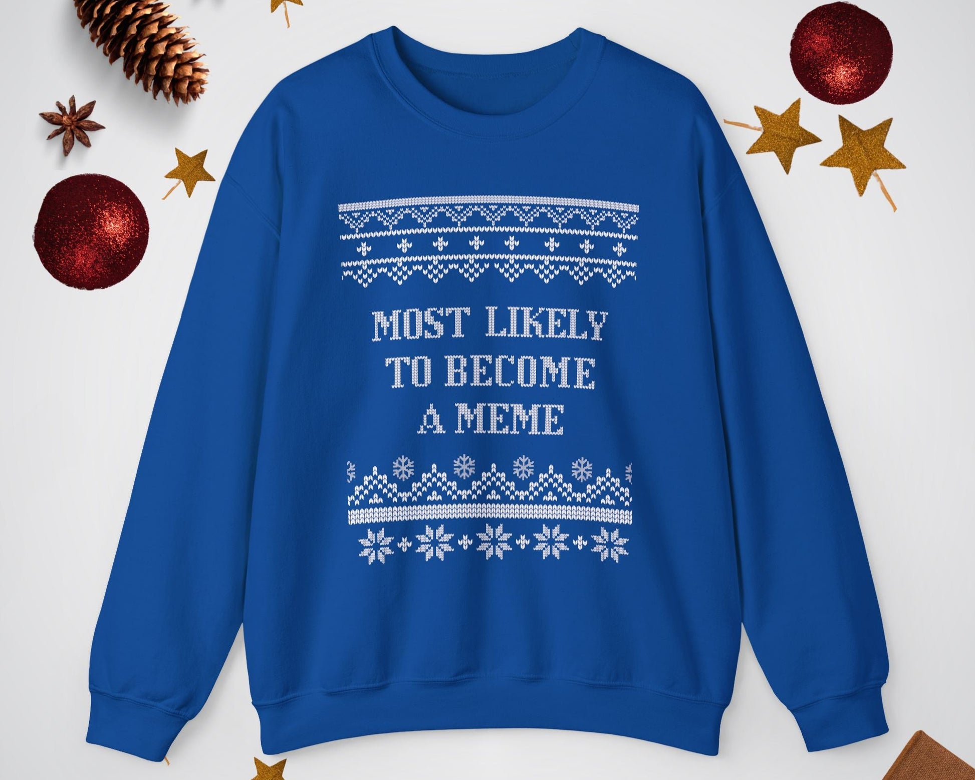 Blue sweatshirt with text and patterns on a light gray background with decorative items.