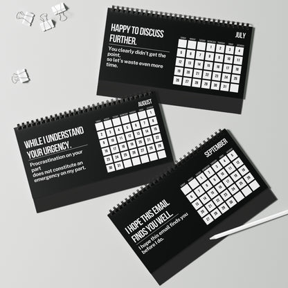 Three black spiral-bound calendars with white text on a gray surface.