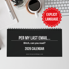 Calendar with explicit language text on a desk with a cup of coffee, pens, and keyboard.