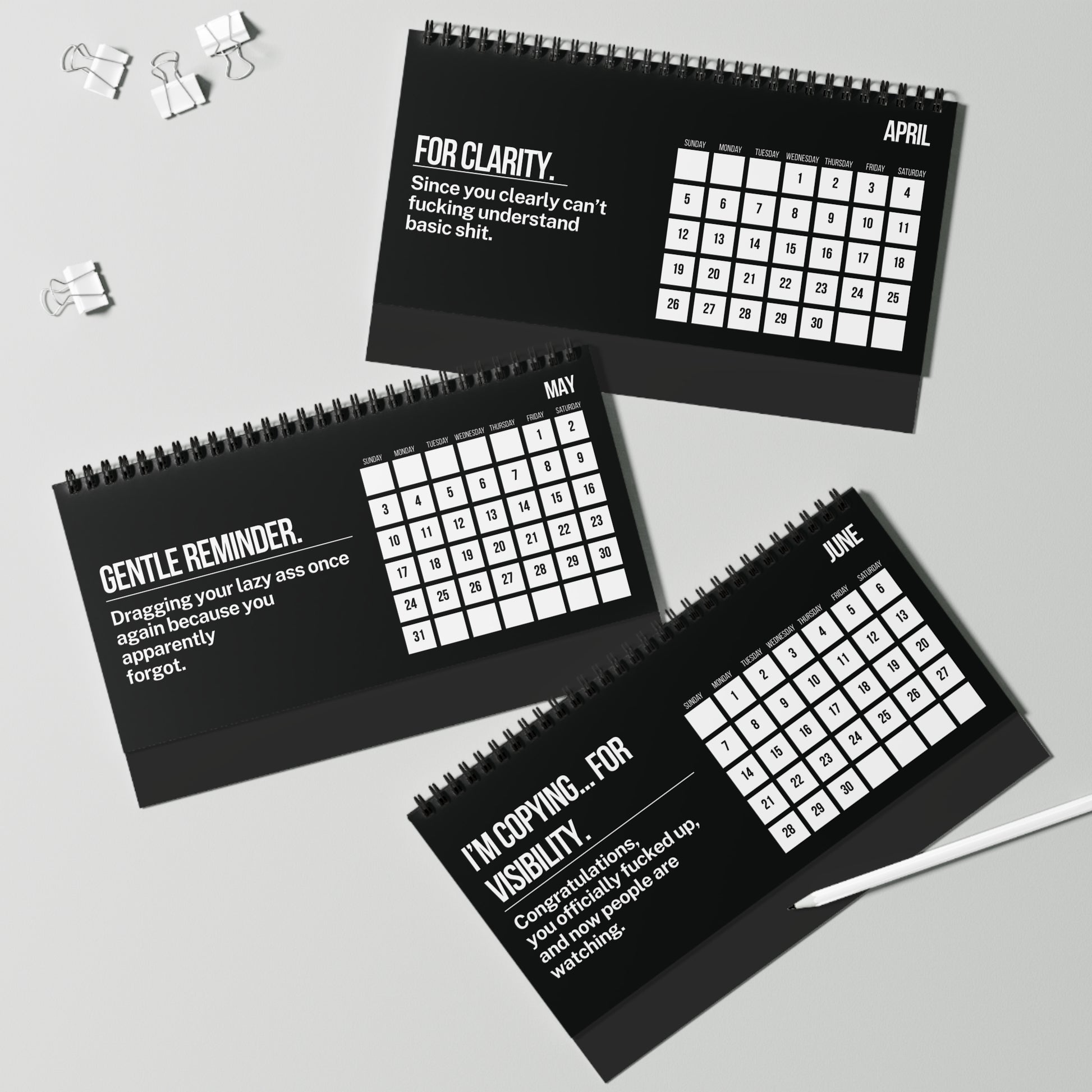 Three black spiral-bound calendars for April, May, and June with humorous text on a gray background.