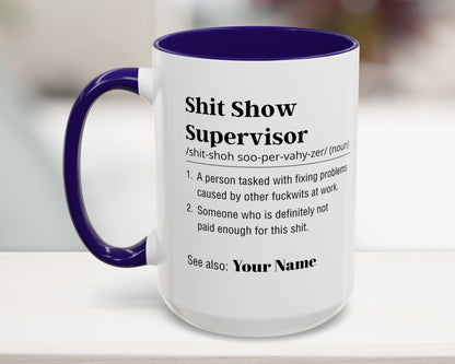 Mug with text definition of 'Shit Show Supervisor' on a blurred background