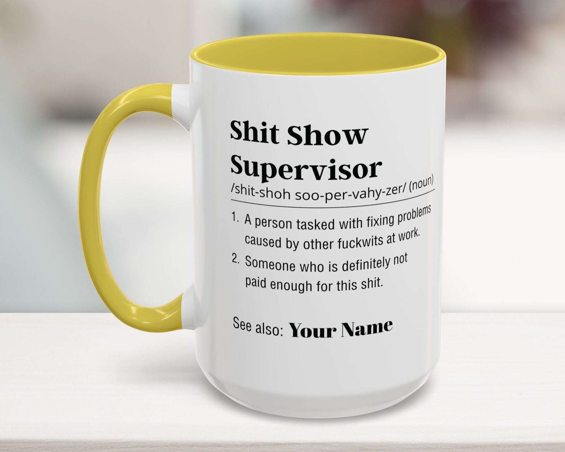 Mug with yellow interior and handle on a blurred background