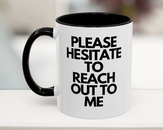 White mug with black interior and handle, featuring text on a blurred background