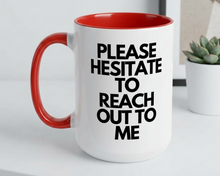 White mug with red interior and handle, featuring black text on a white surface.