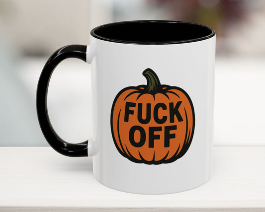 Mug with a pumpkin design and text on a white surface