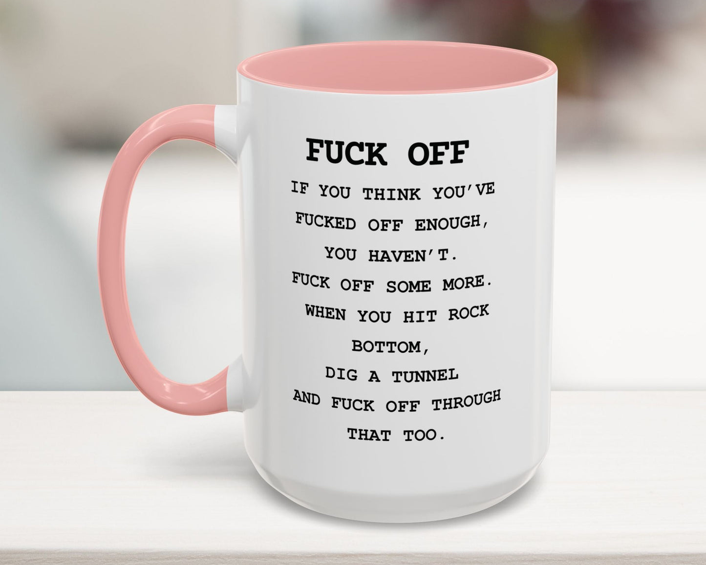 Mug with pink handle and text on a blurred background