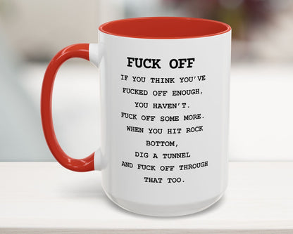 Mug with red interior and handle, featuring a message on a blurred background