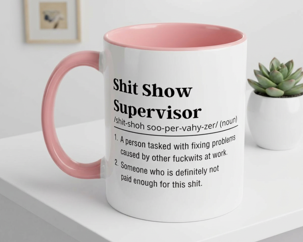 Mug with pink interior and handle on a white surface, featuring text.