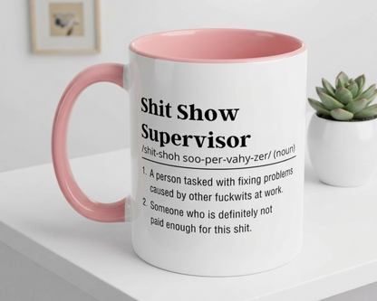Mug with pink interior and handle on a white surface, featuring text.