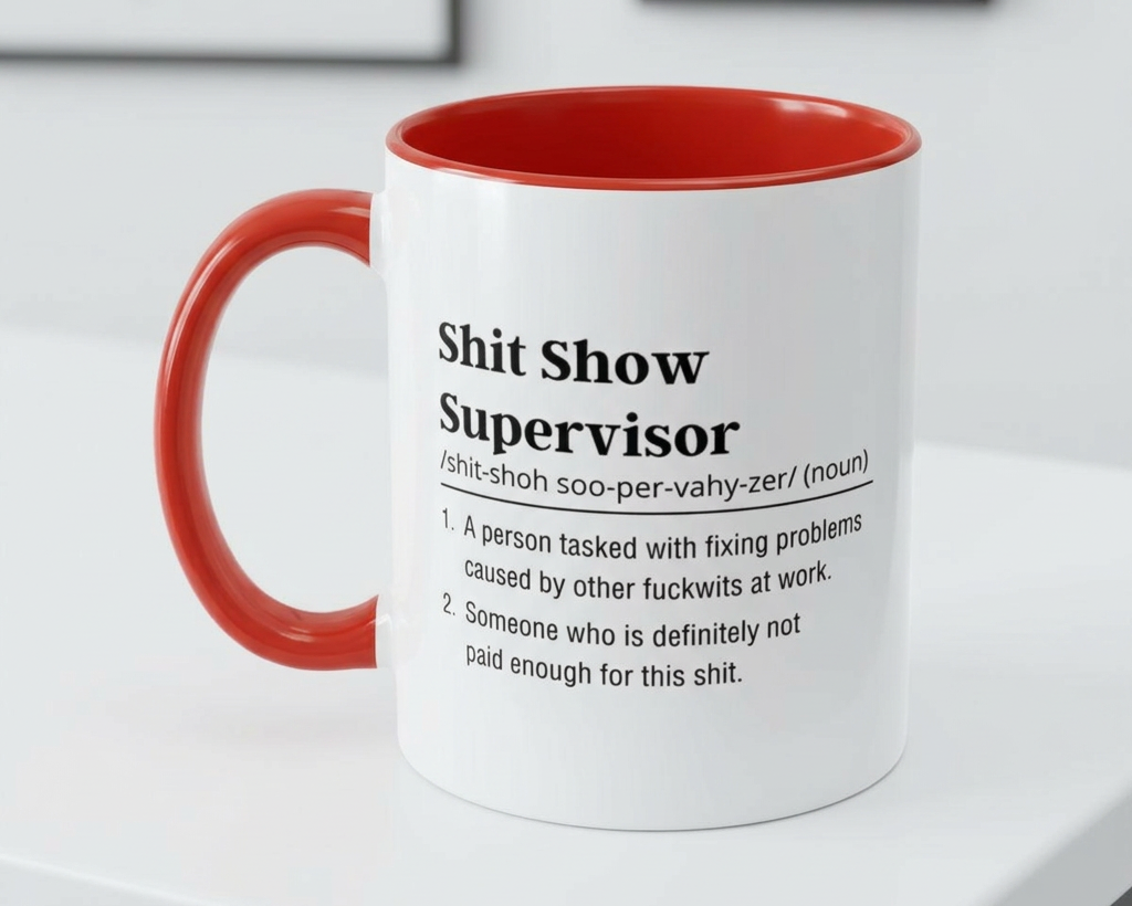 Mug with red interior and handle, featuring text on a white surface.