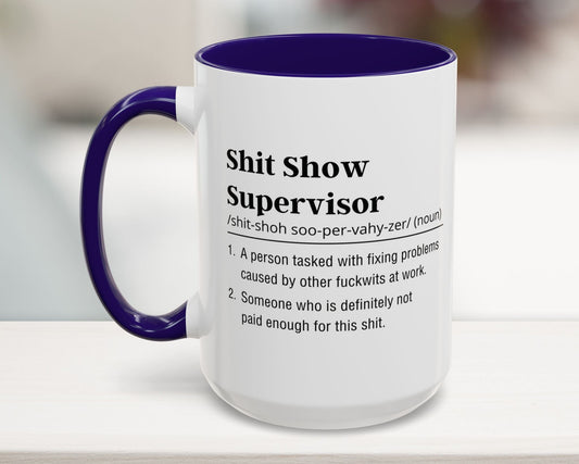 Mug with purple handle and blue interior, featuring text on a blurred background
