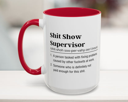 Mug with red interior and handle featuring humorous definition text on a blurred background