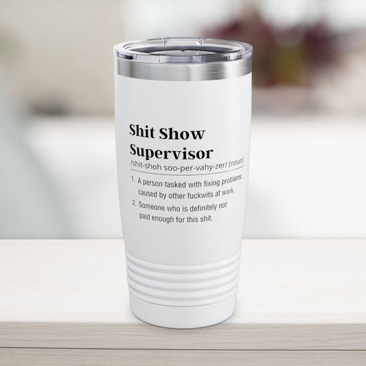 Shit show supervisor White tumbler with black text on a blurred background