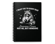 Notebook cover featuring raccoon hugging possum and quote: ‘Someone Cares Not me, But someone'
