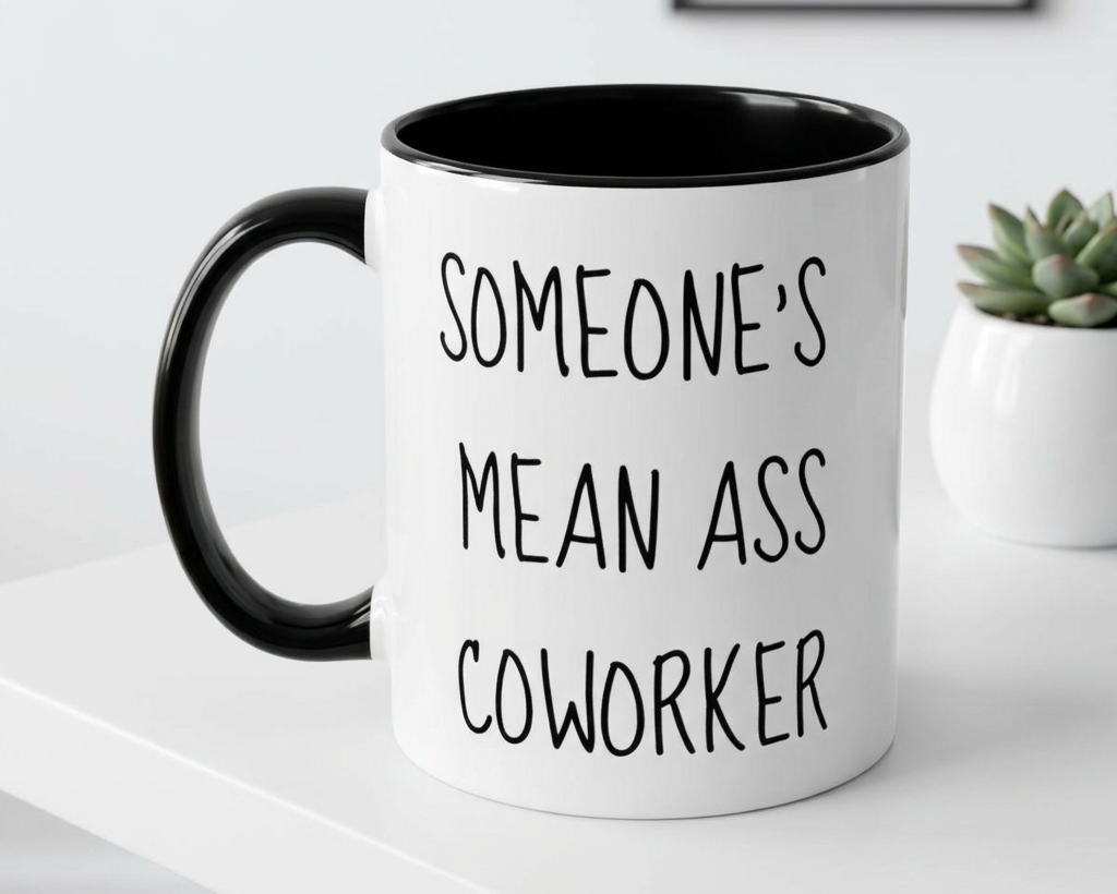 White mug with black interior and handle, featuring text, on a white surface.