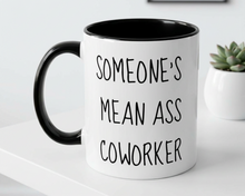 White mug with black interior and handle, featuring text, on a white surface.