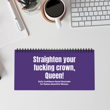 Flip desk sign in purple reading ‘Straighten Your F*cking Crown’ on a work desk