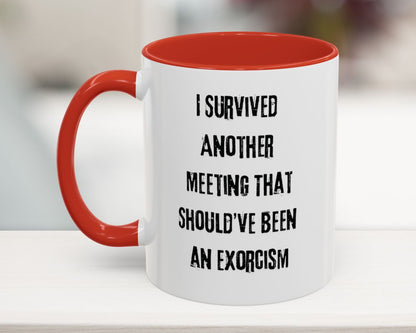 White mug with red interior and handle, featuring a humorous text on a blurred background