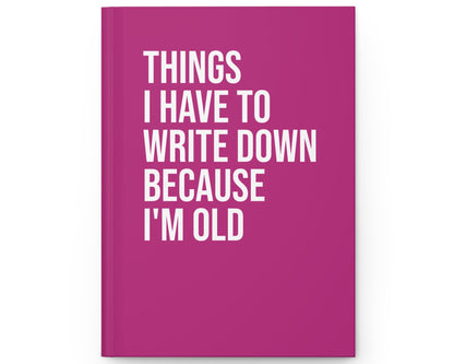 Pink notebook with white text on a white background
