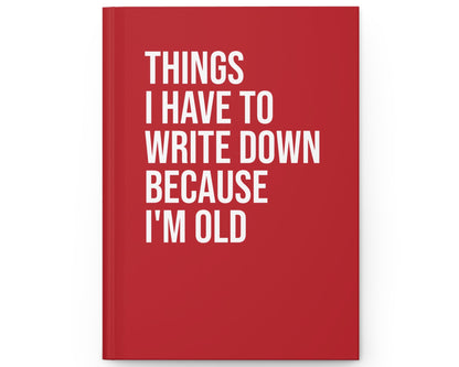Red notebook with white text on a white background