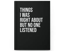 Black notebook with white text on a white background