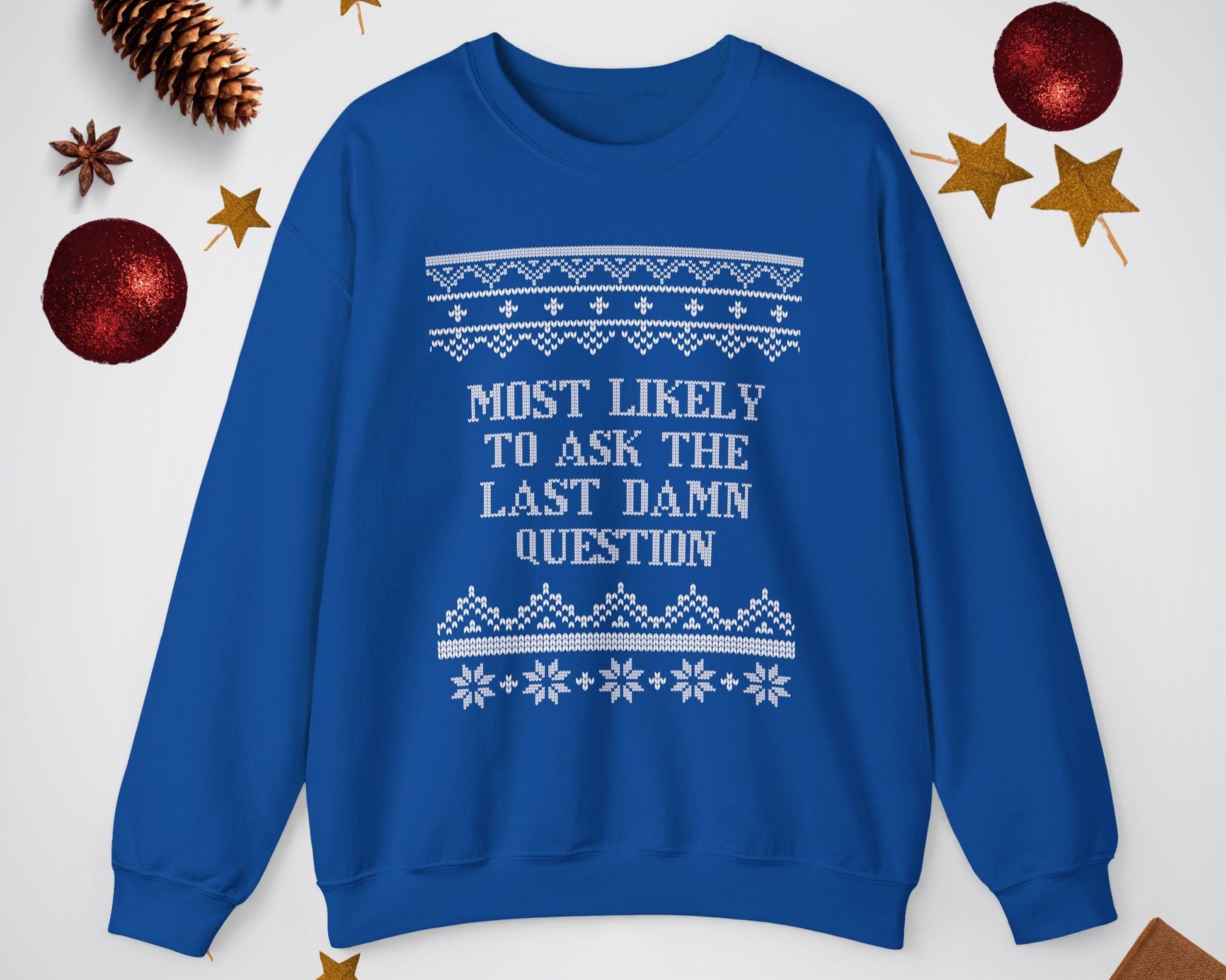 Blue sweatshirt with text and patterns on a light gray background with decorative items.