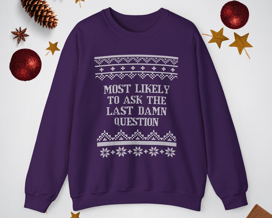 Purple sweatshirt with text and patterns on a light gray background with decorative items.