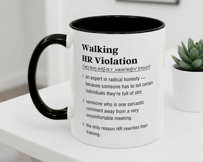 Mug with humorous definition text on a white surface with a plant in the background