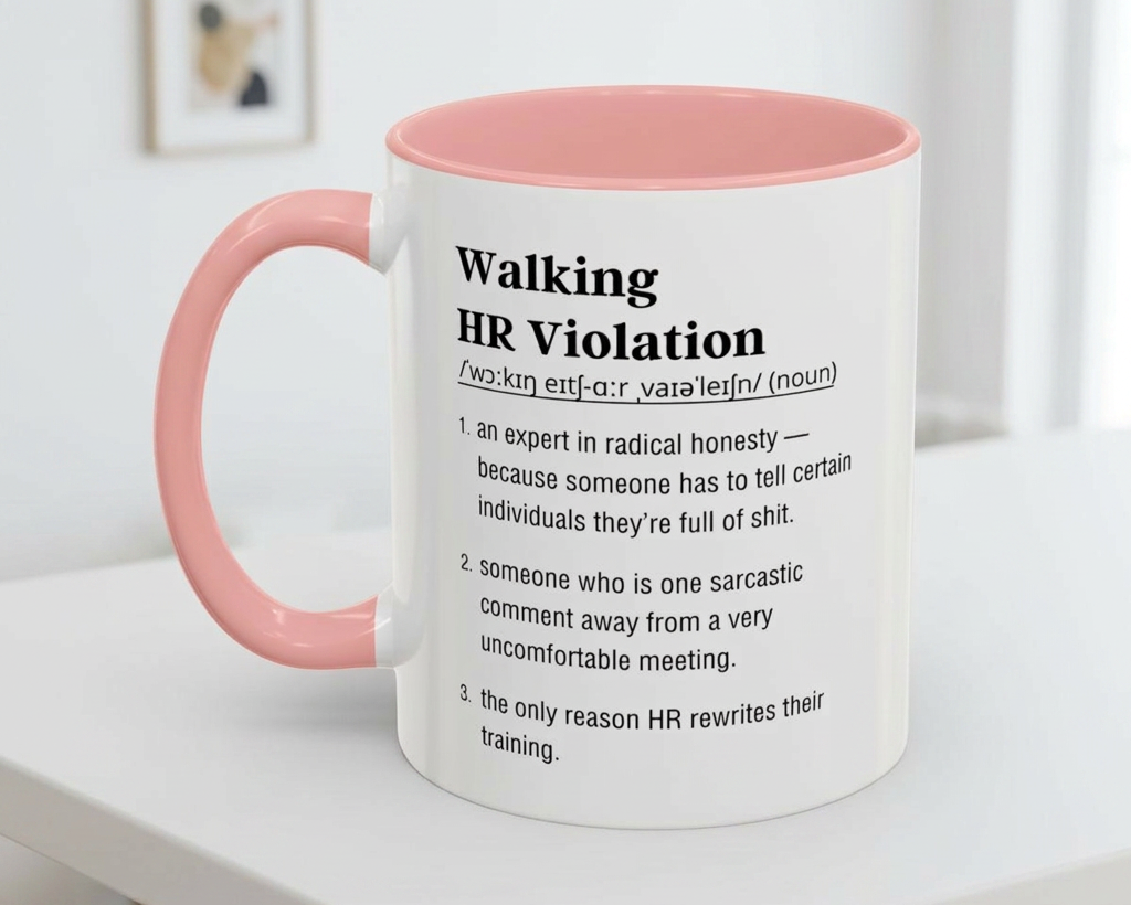 Mug with pink handle and humorous definition text on a white surface.