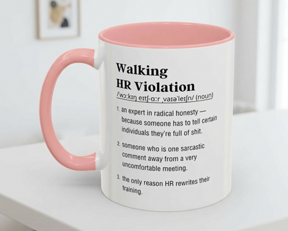 Mug with pink handle and humorous definition text on a white surface.