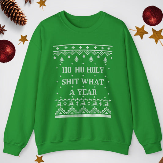 Green sweater with Christmas-themed text and patterns on a white background with festive decorations.
