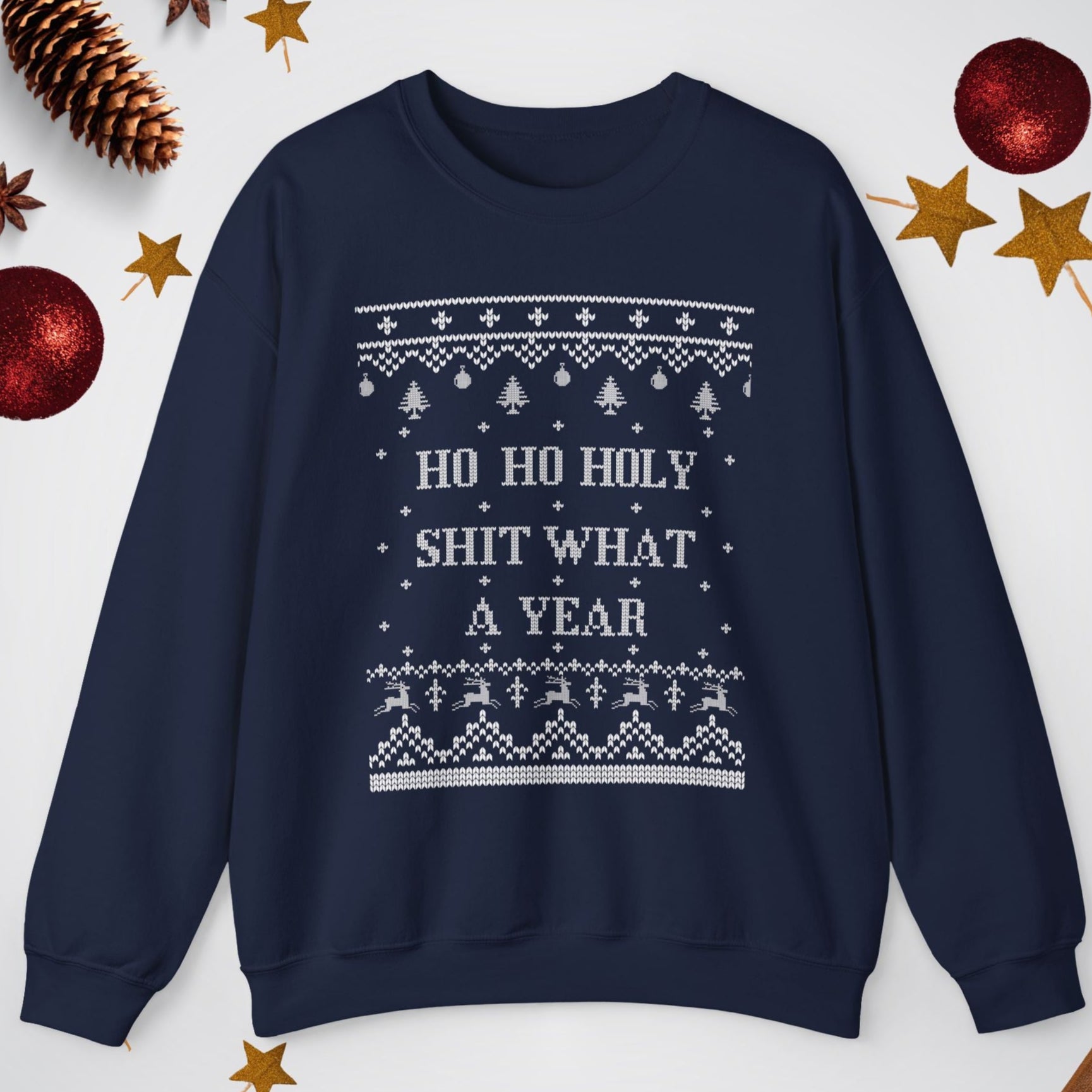 Navy blue sweatshirt with Christmas-themed text and patterns on a white background with festive decorations.