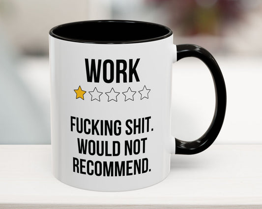 Mug with text 'WORK ★★★★ F***ING SHIT. WOULD NOT RECOMMEND.' on a blurred background