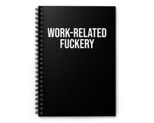 Black spiral-bound notebook with white text on a white background